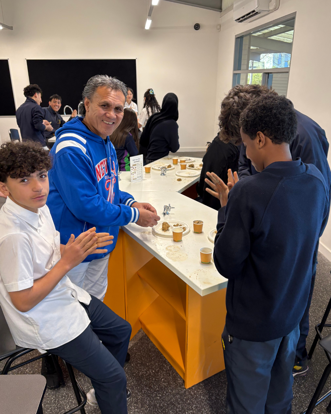 Students and educator working together around a classroom table