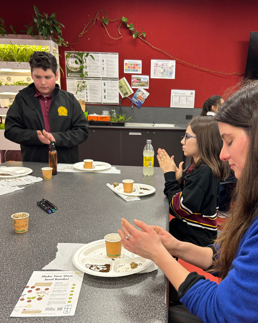 Students making seed bombs during a Farmwall incursion