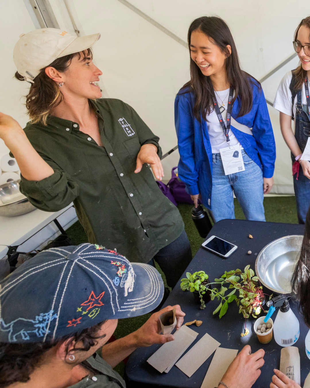 Farmwall educator demonstrating seed bomb making to students