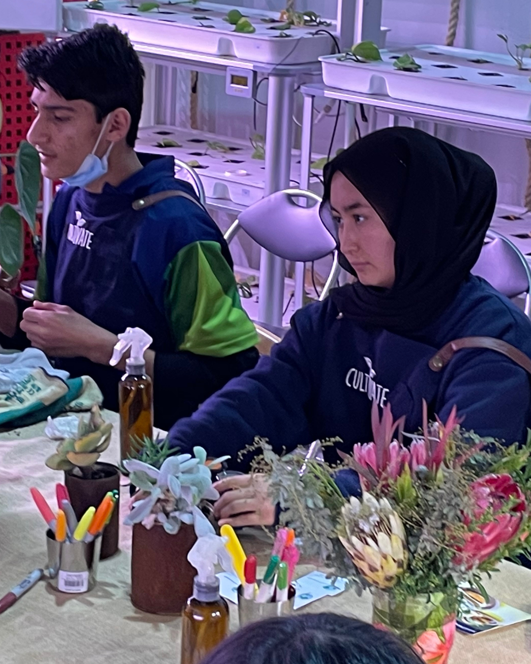 Students working with plants and floral materials in a growing classroom