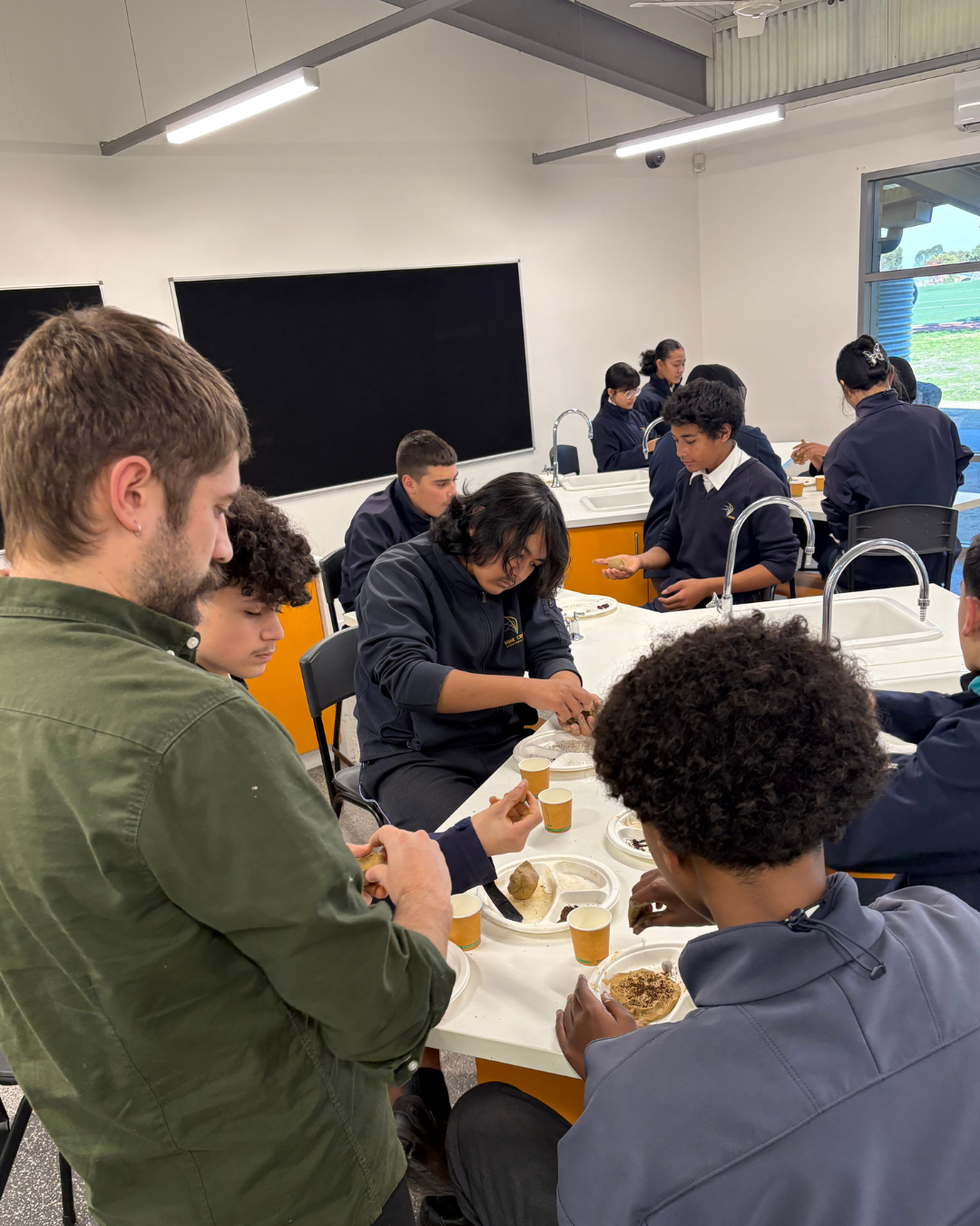 Students doing hands-on work at classroom tables