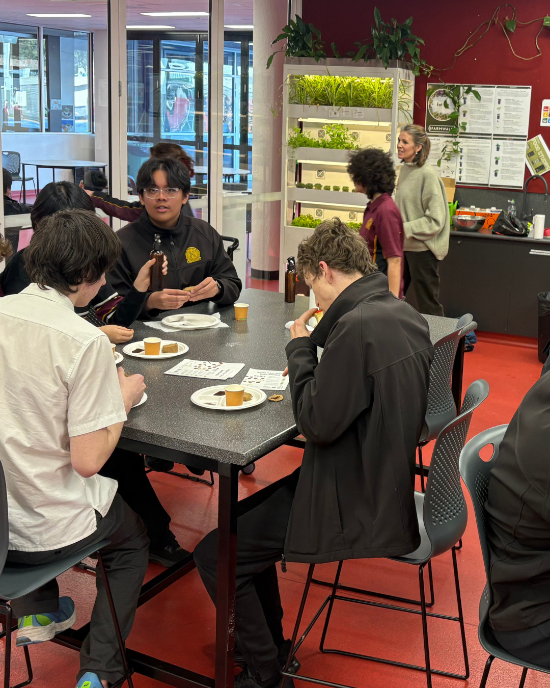 Students tasting microgreens at a class table